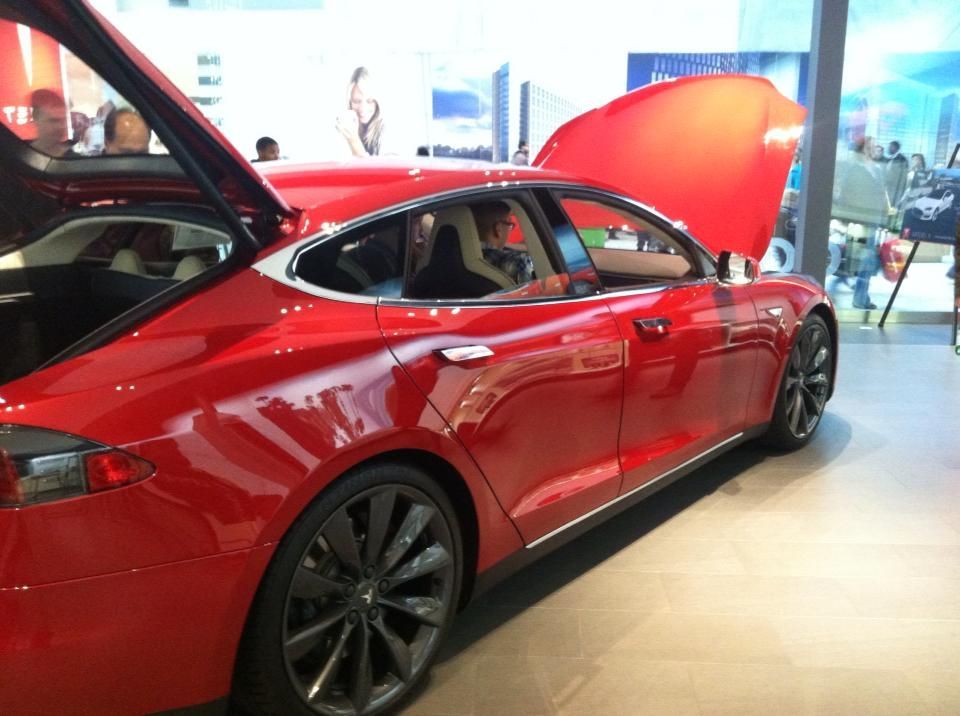 A red tesla model s with the hood up