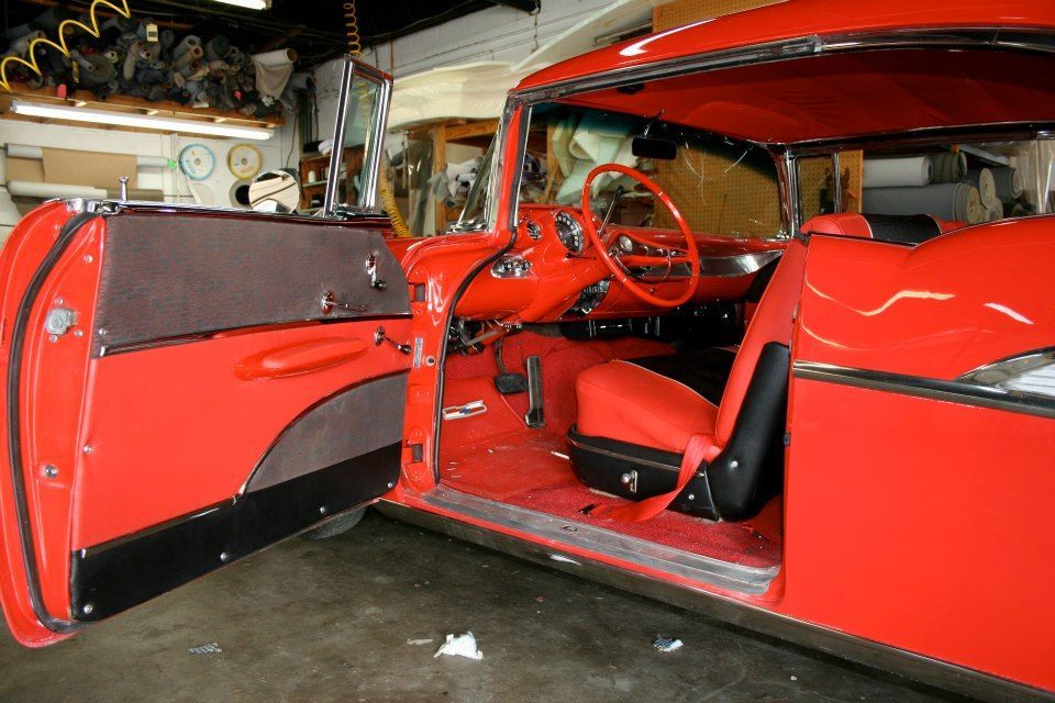 The inside of a red car with the door open