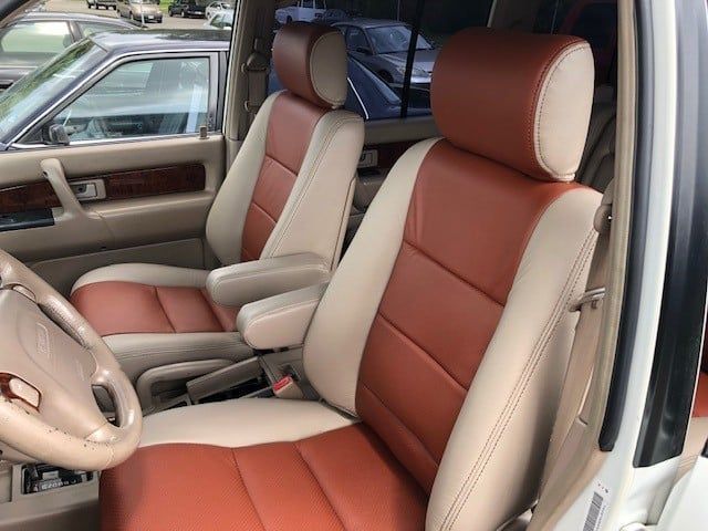 A white car with brown and white leather seats