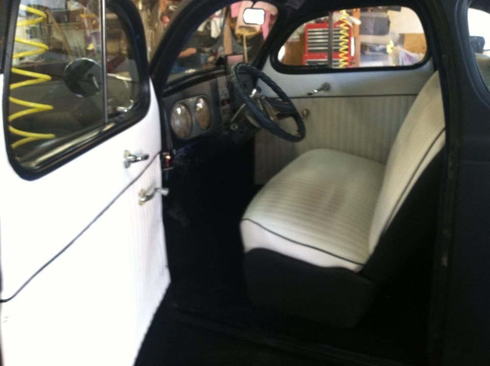 The inside of a white car with a steering wheel