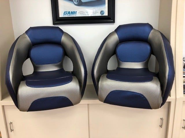 Two blue and gray chairs are sitting next to each other