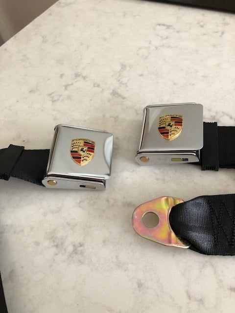 A pair of seat belts with a porsche logo on them