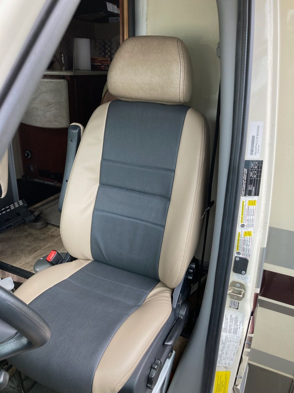A car seat with a gray and tan seat cover