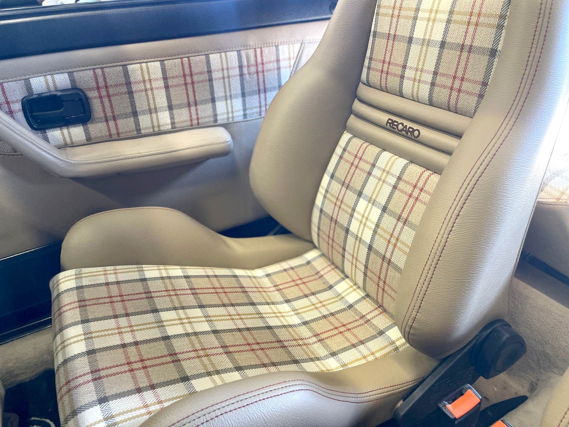 New beige auto seat with plaid fabric inset