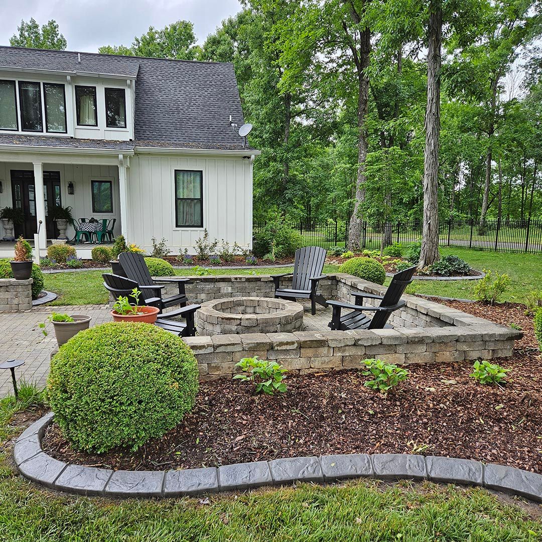 A cobblestone curb is surrounding a garden.