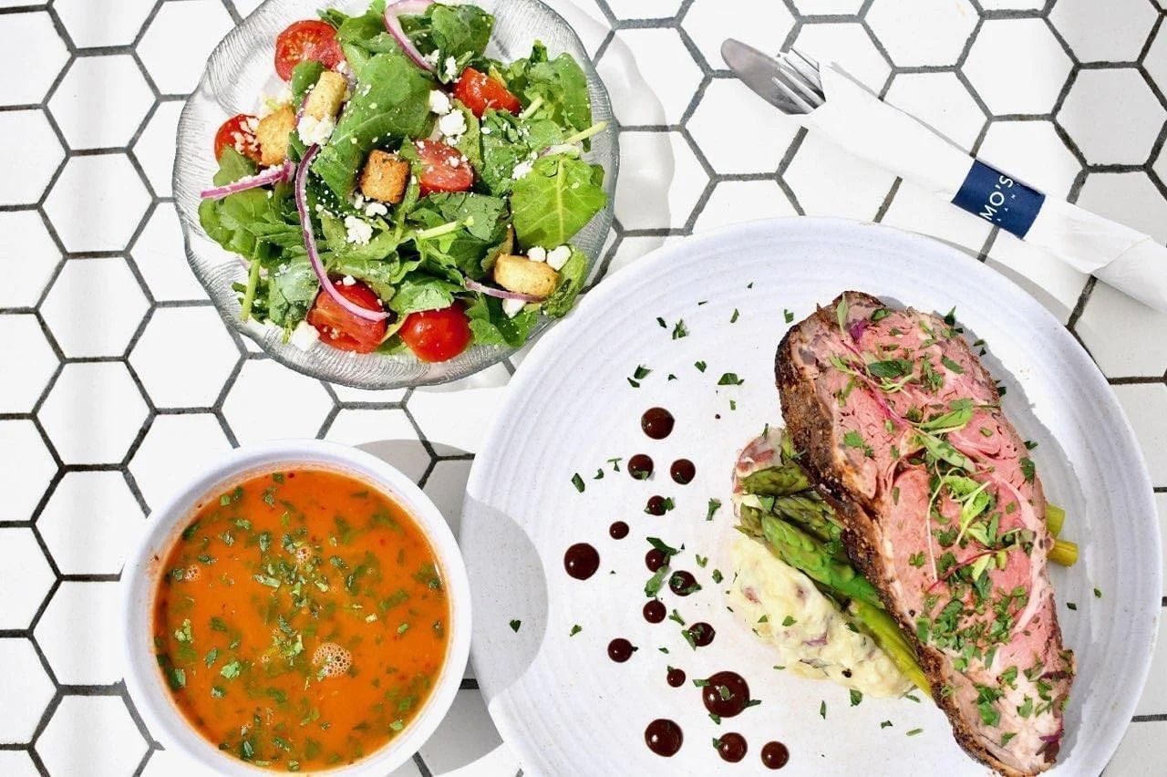 Gourmet meal on a white honeycomb-tiled table.