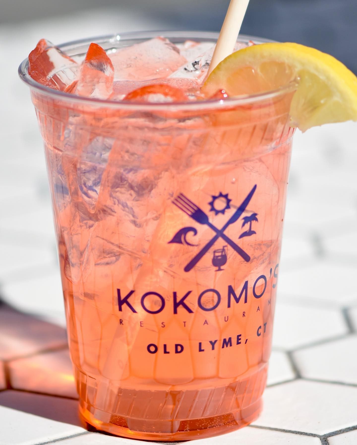 A drink in a plastic cup that says kokomo old lyme