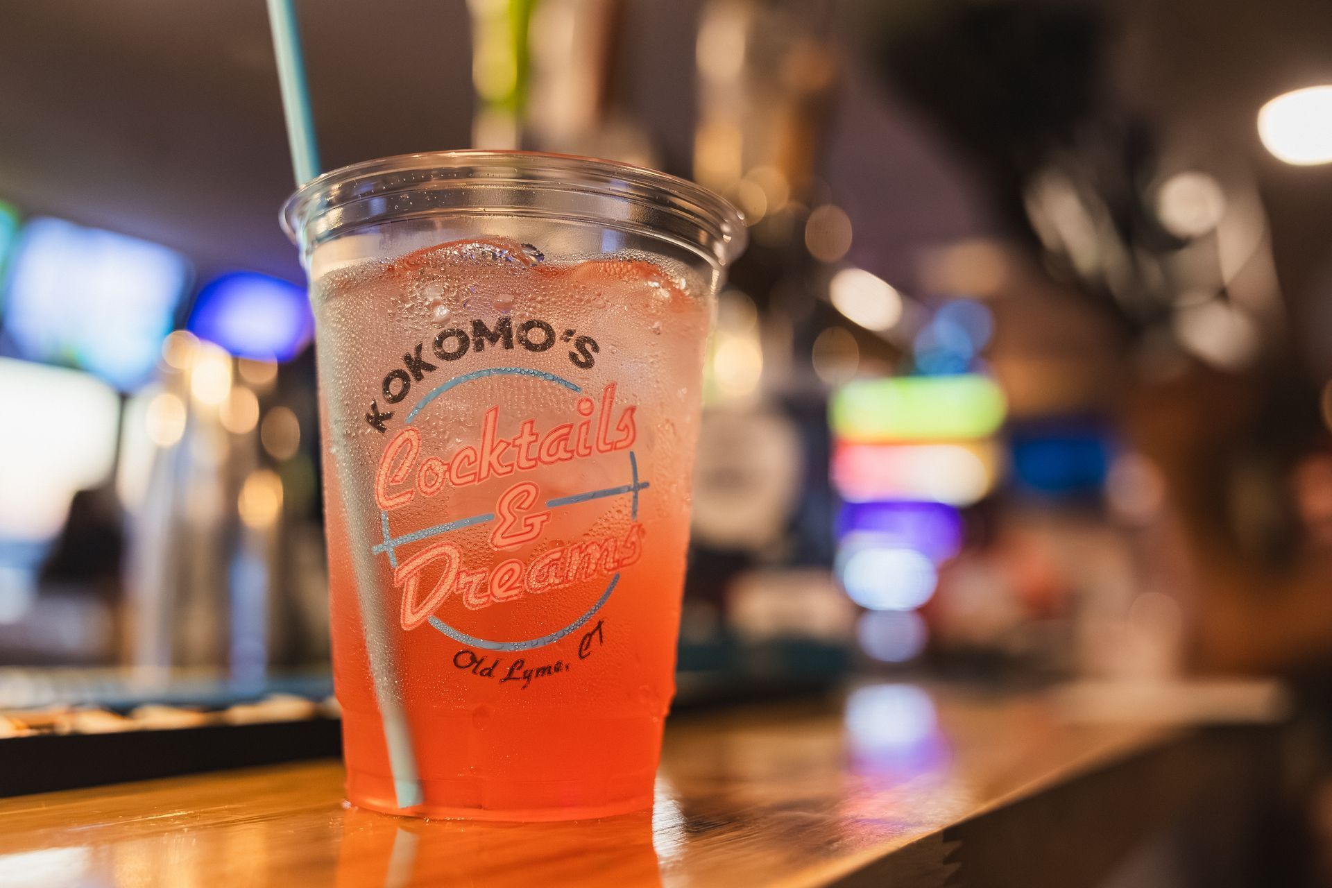 A cocktail in a cup with a straw