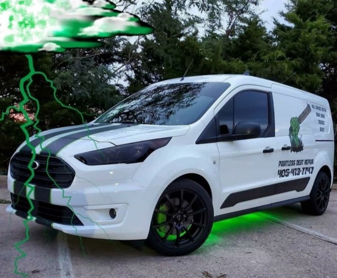 White van with black accents, green underglow and lightning. Marketing for 