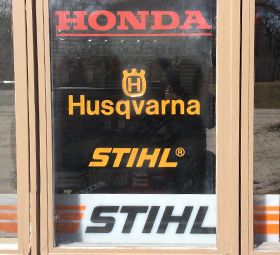 Honda, Husqvarna, Stihl window advertisements