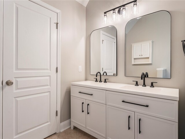 Bathroom with white vanity, black hardware, arched mirrors, and a white door.
