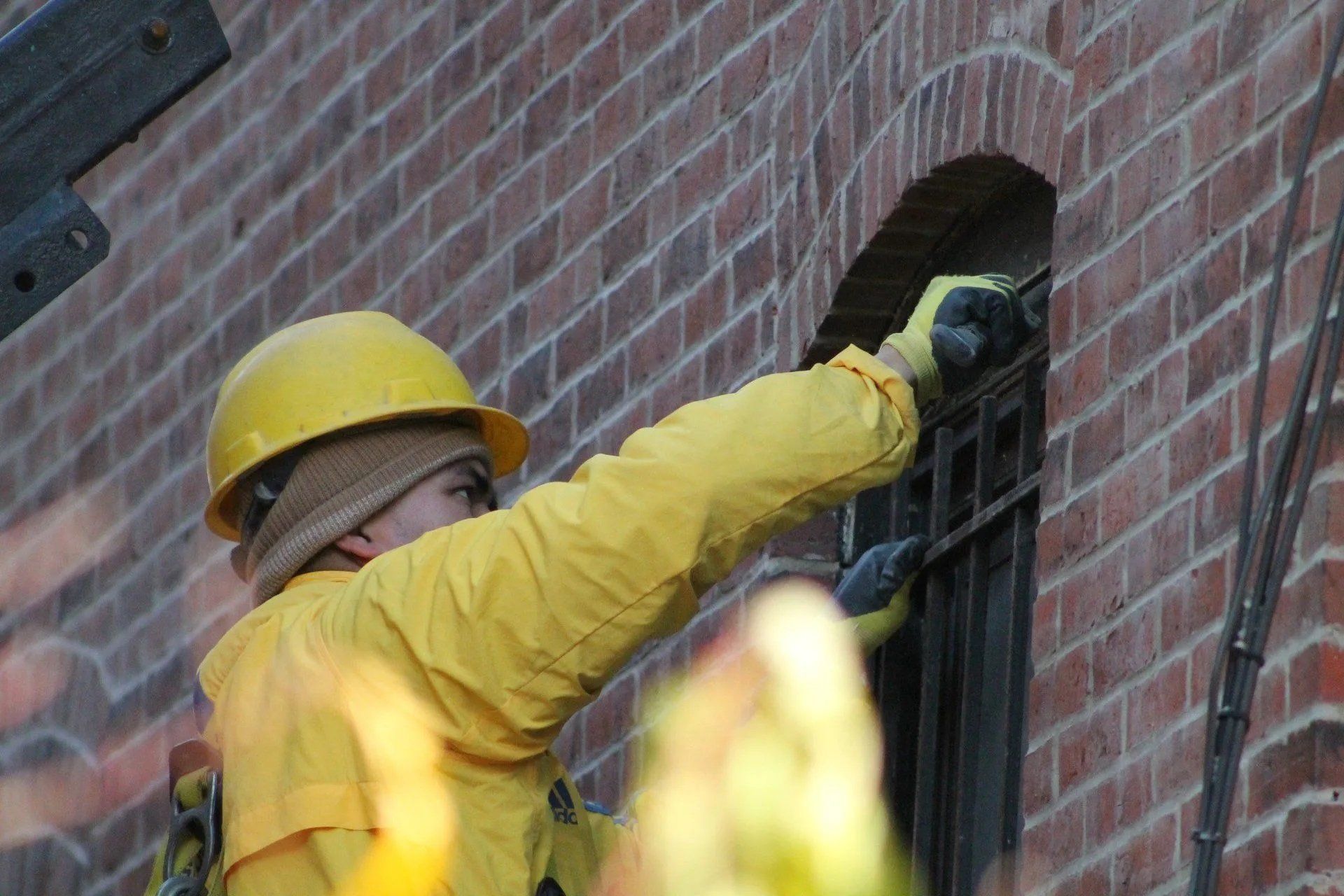 Man on a lift platform repairing the side of a building