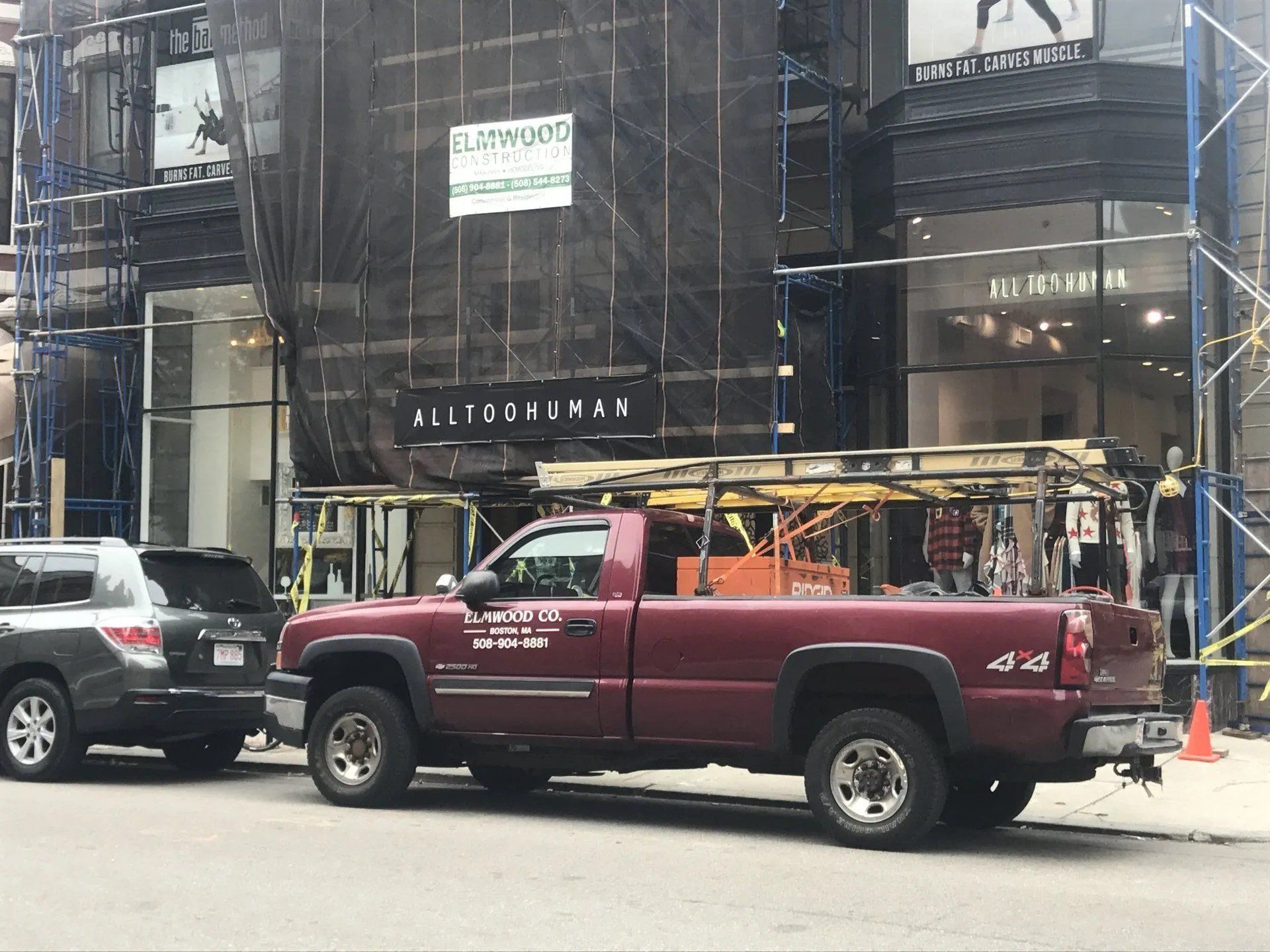Repair pickup truck parked in front of a commercial building being that's being repaired