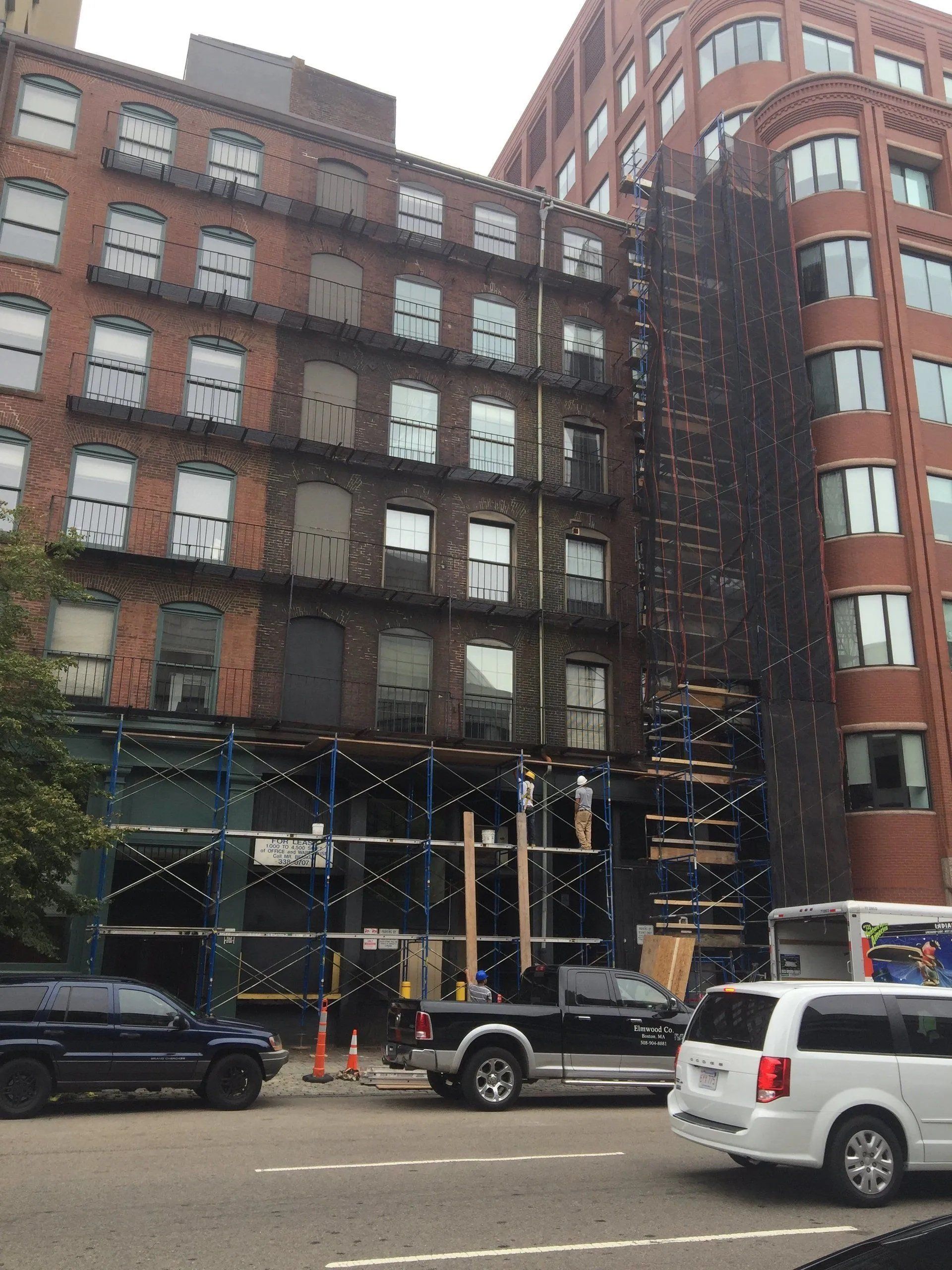 Building under construction with black safety net