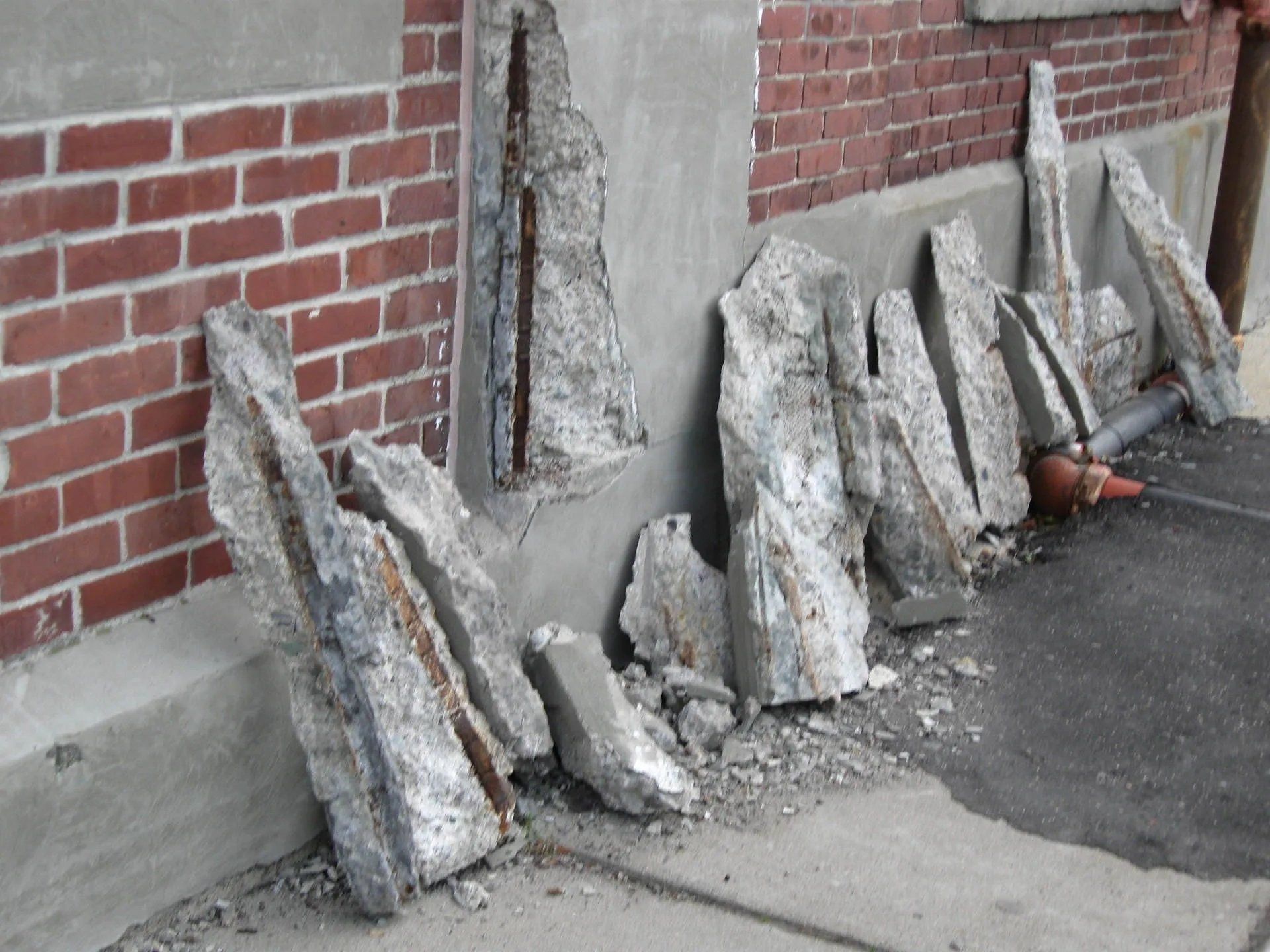 Building wall with broken concrete debris
