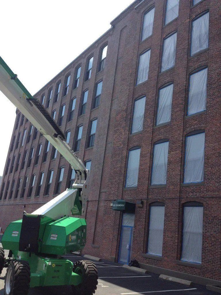 Aerial concrete truck next to a commercial building