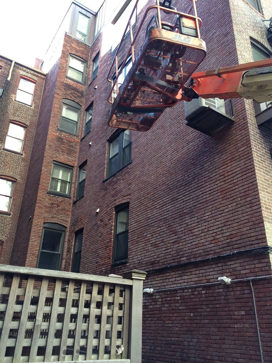 Aerial lift positioned next to a building