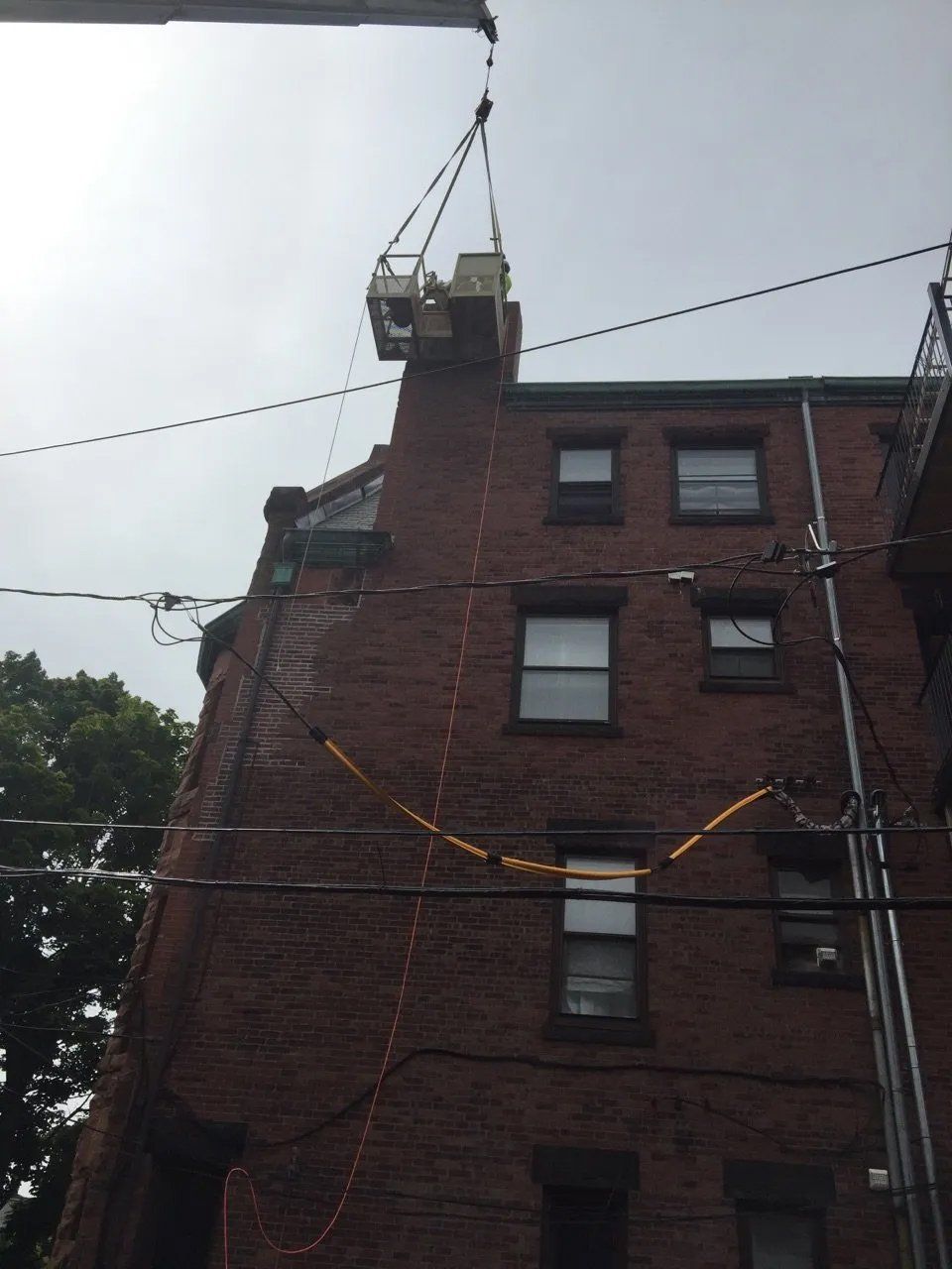 Large chimney repair, work carried out with crane and man lift