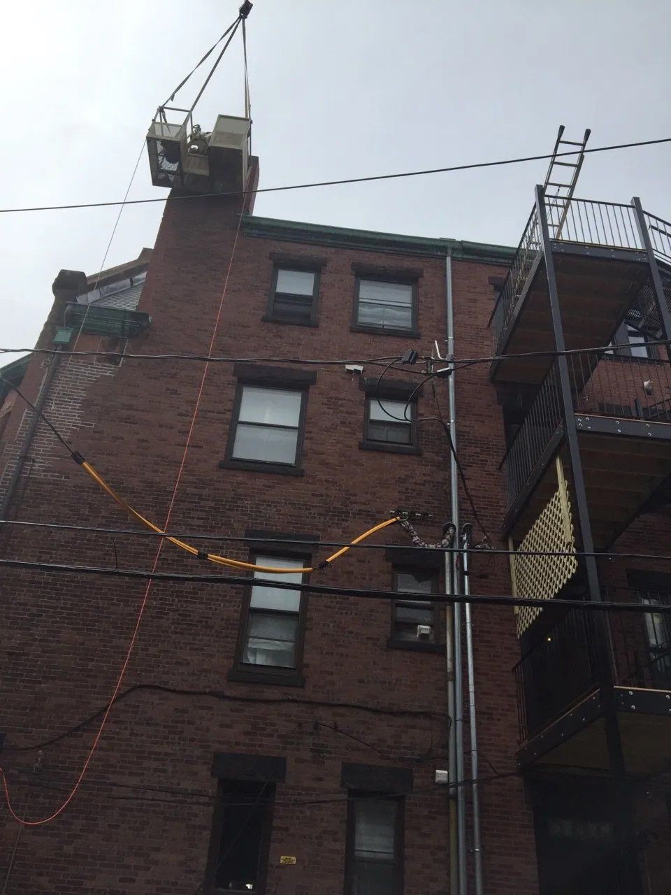 Large chimney repair, work carried out with crane and man lift