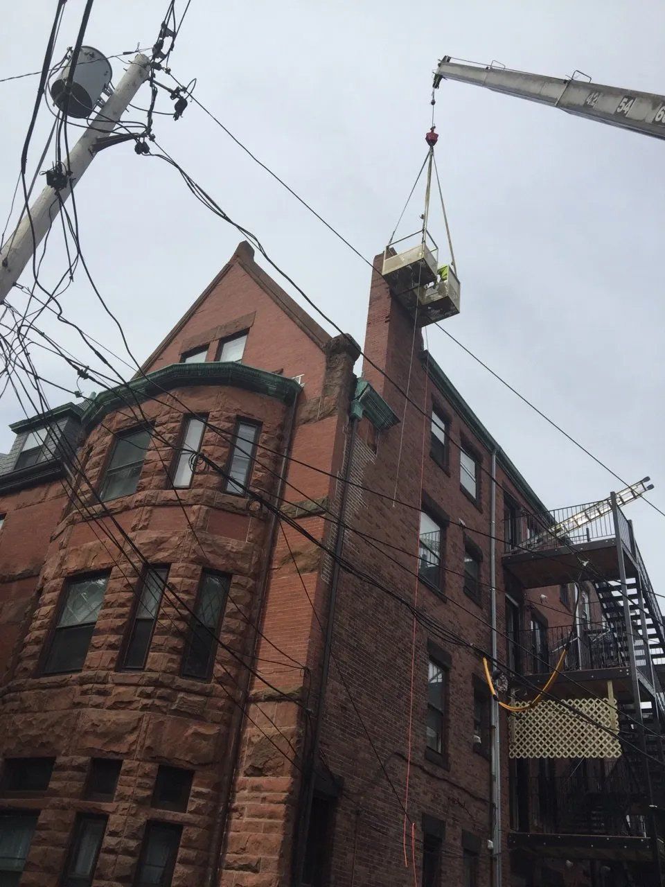 Large chimney repair, work carried out with crane and man lift
