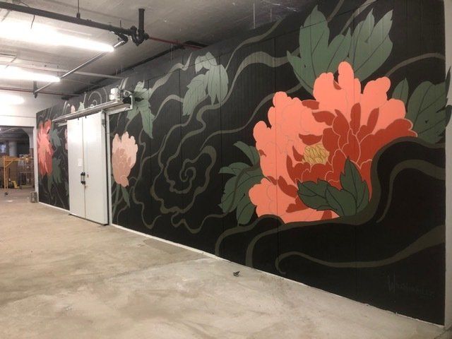 A wall with a painting of flowers on it