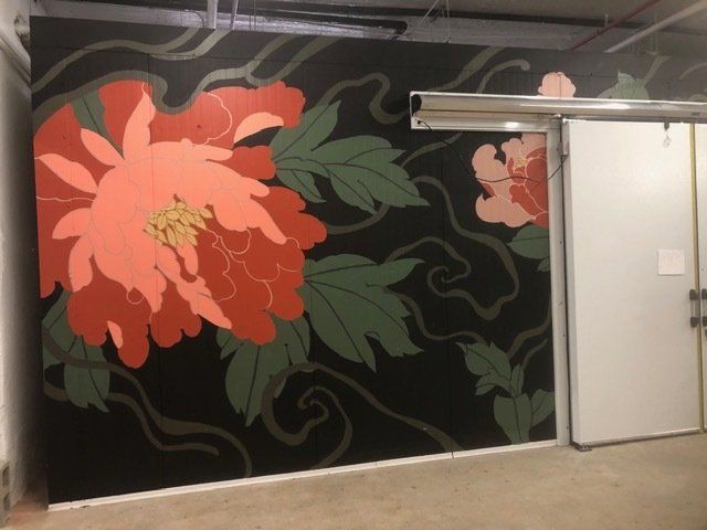 A wall with a painting of flowers on it