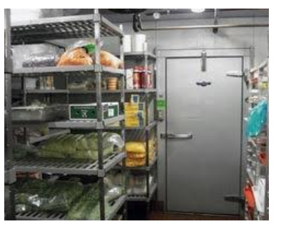 A room filled with shelves filled with food and a door.