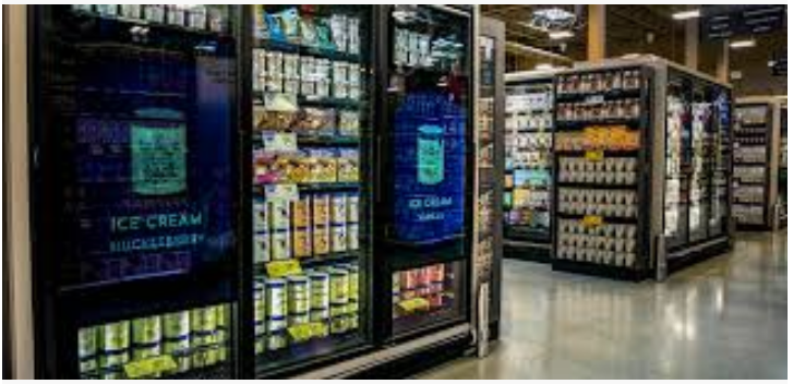A grocery store filled with lots of fridges and shelves.