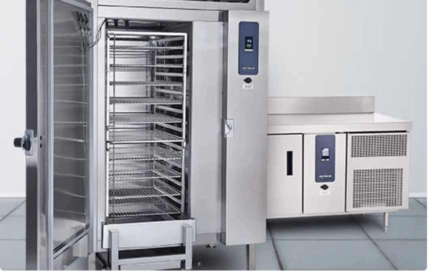 A stainless steel refrigerator with the door open and a counter in the background.