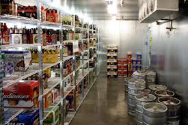 A warehouse filled with lots of beer bottles and kegs.