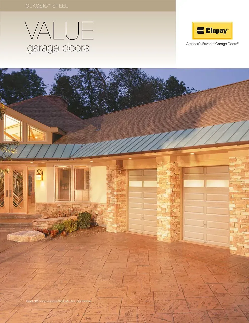 Brick house with two garage doors and a stamped concrete driveway at dusk