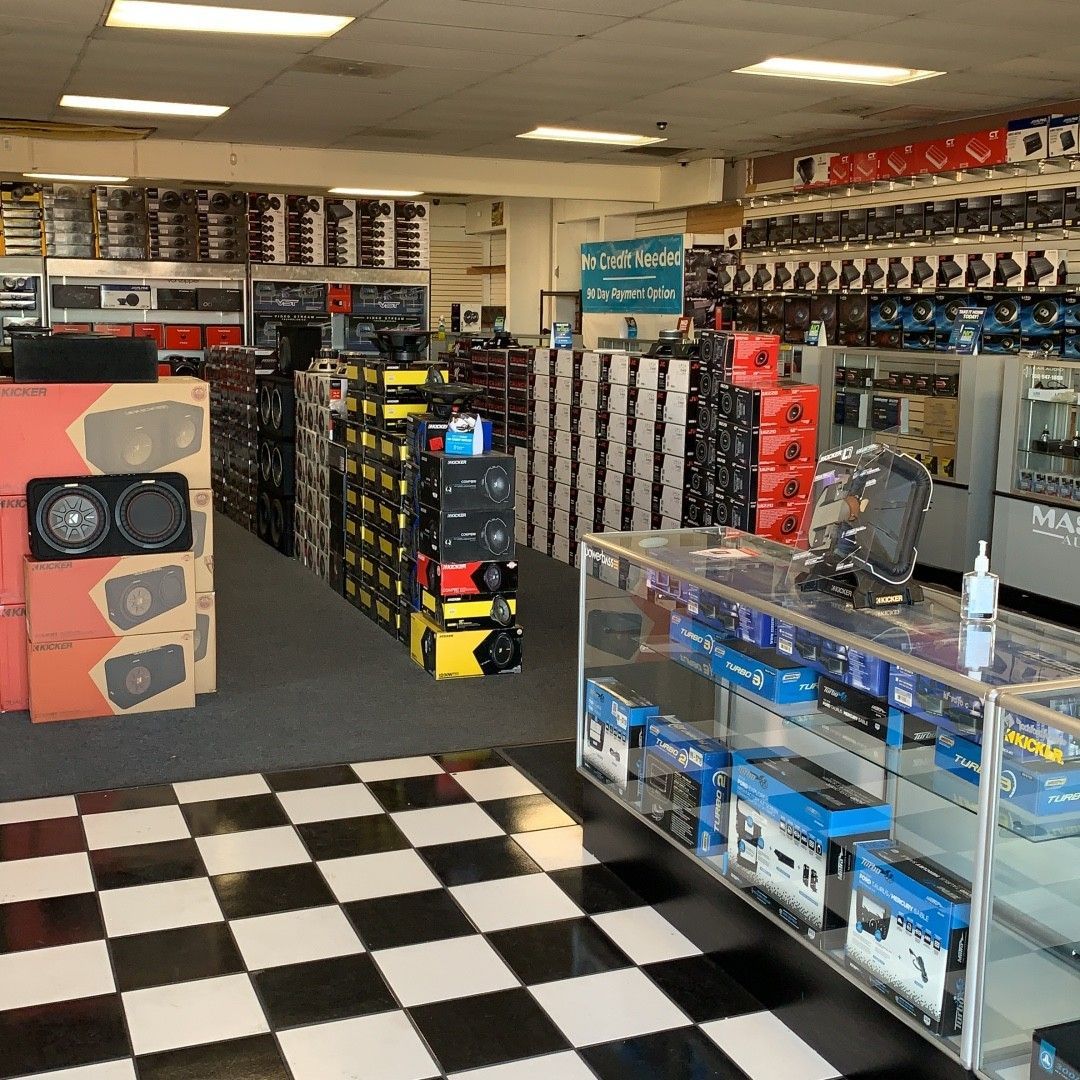 A store filled with lots of speakers and a checkered floor