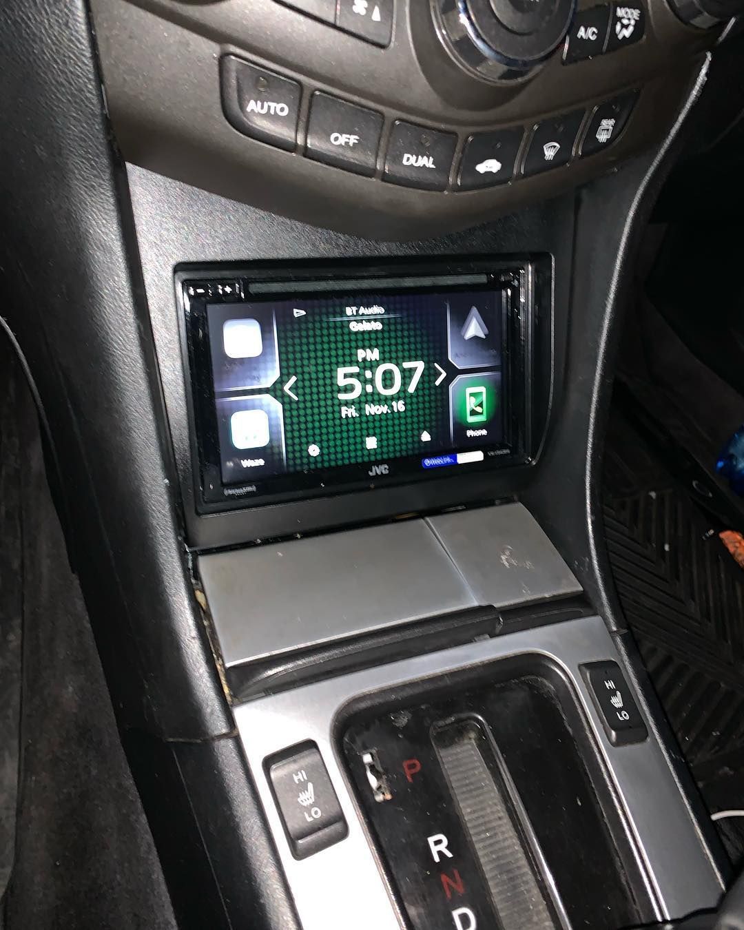 The clock on the dashboard of a car shows the time as 5:07