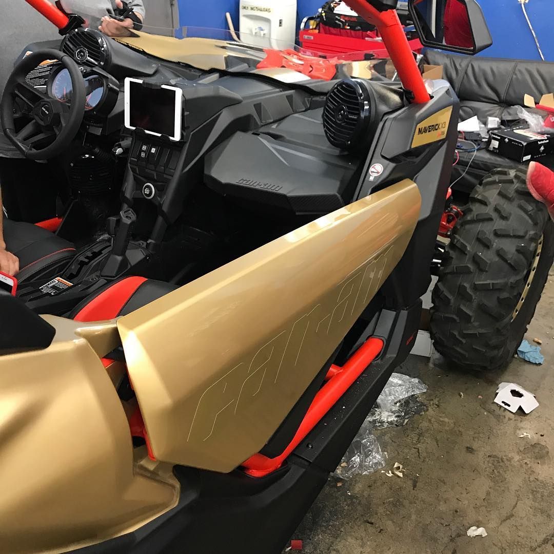 A gold and red atv is parked in a garage
