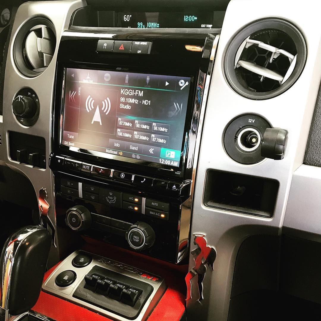 A car dashboard with a radio and a clock on it