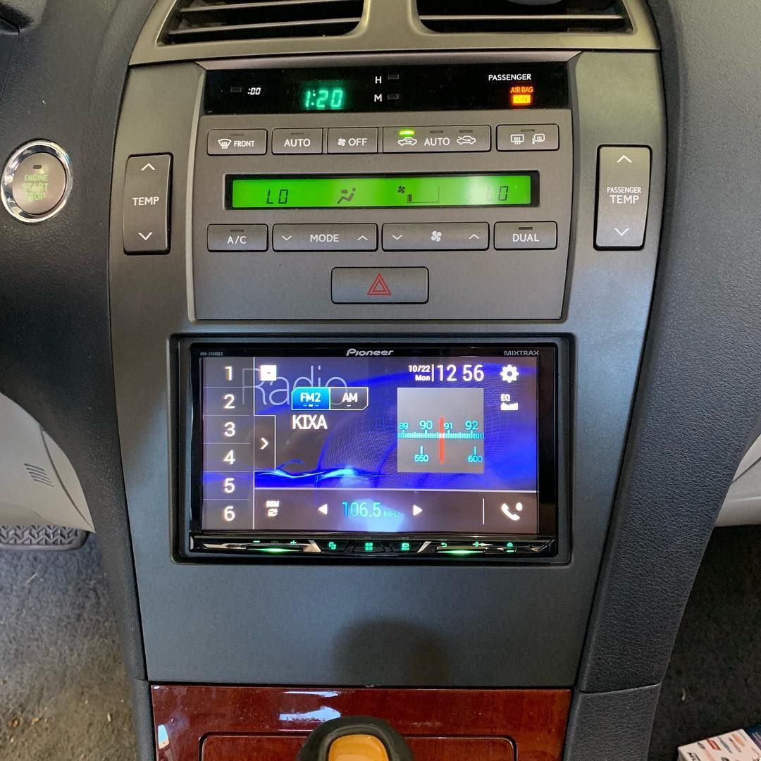 A car dashboard with a radio and a screen that says 12:56