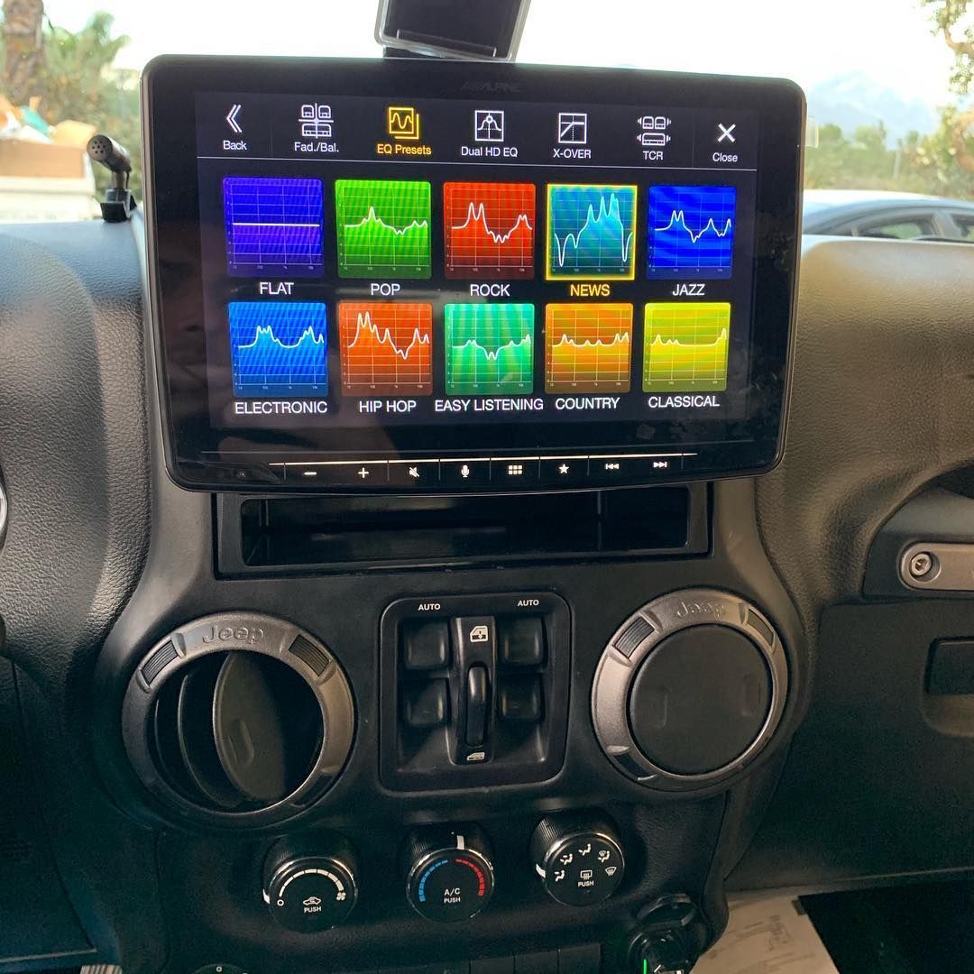 The dashboard of a jeep with a touchscreen display