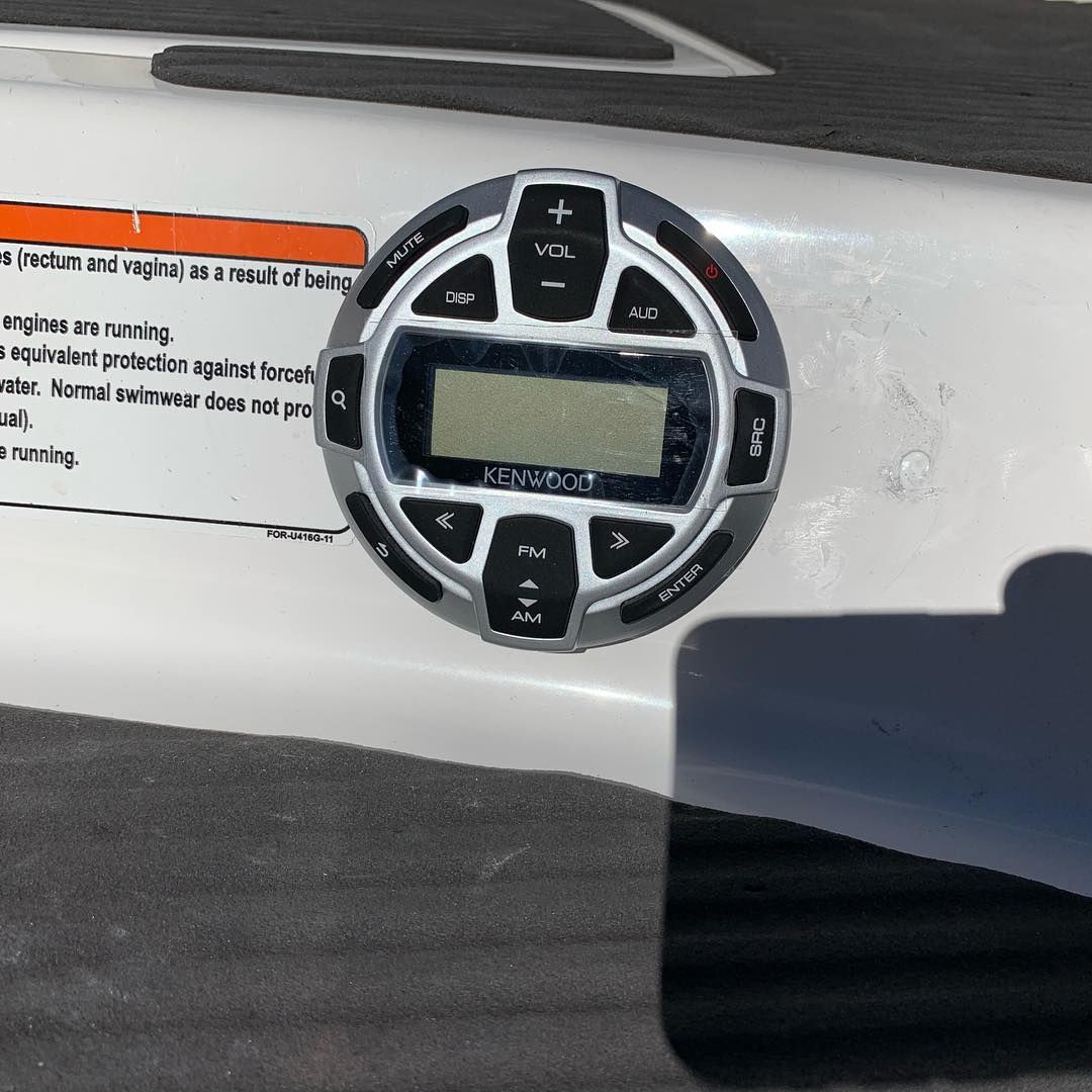 A boat has a radio on the side of it