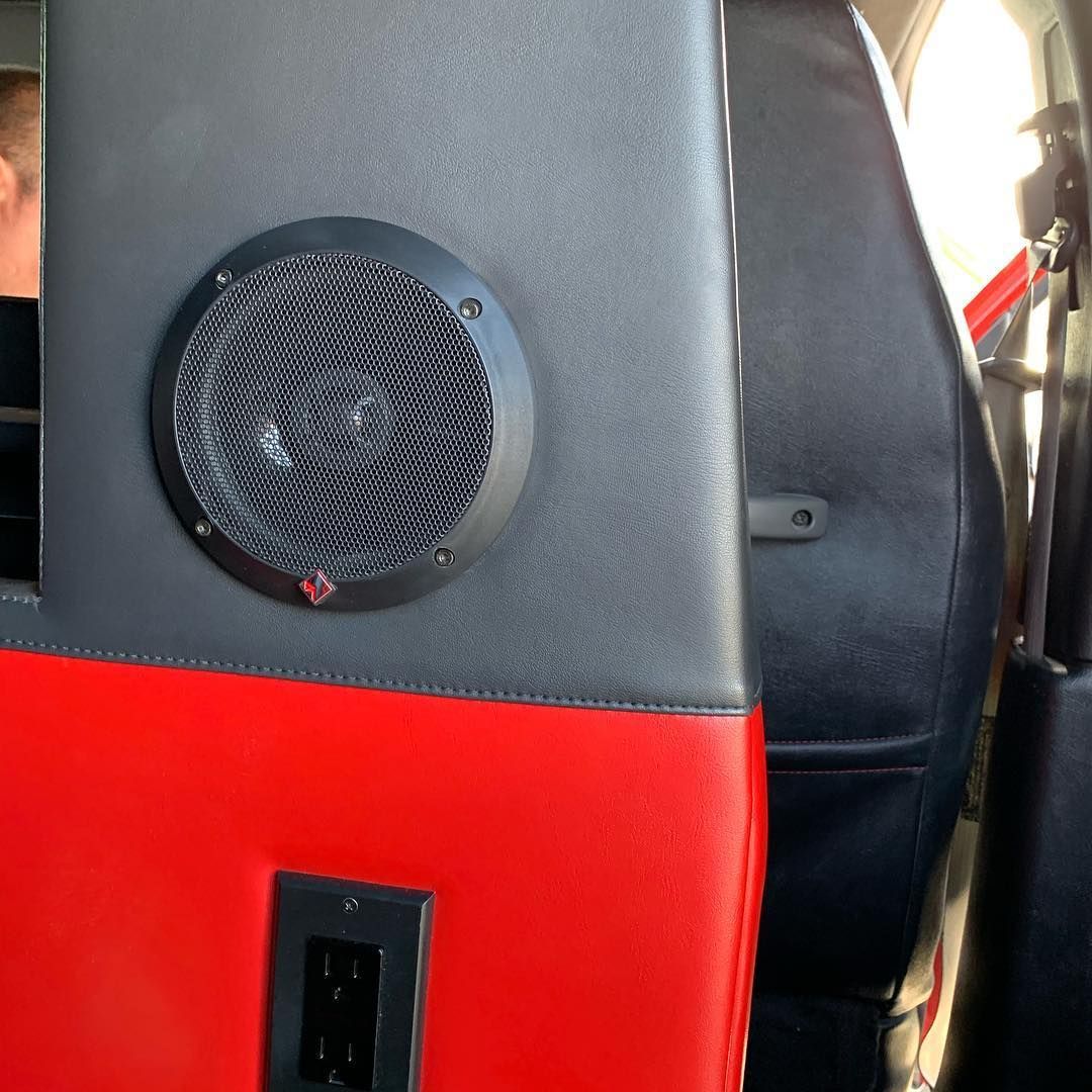A speaker in the back of a red and black car