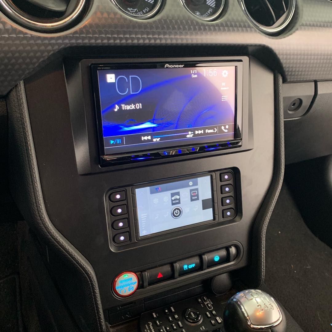 A car dashboard with a cd player and a remote control.
