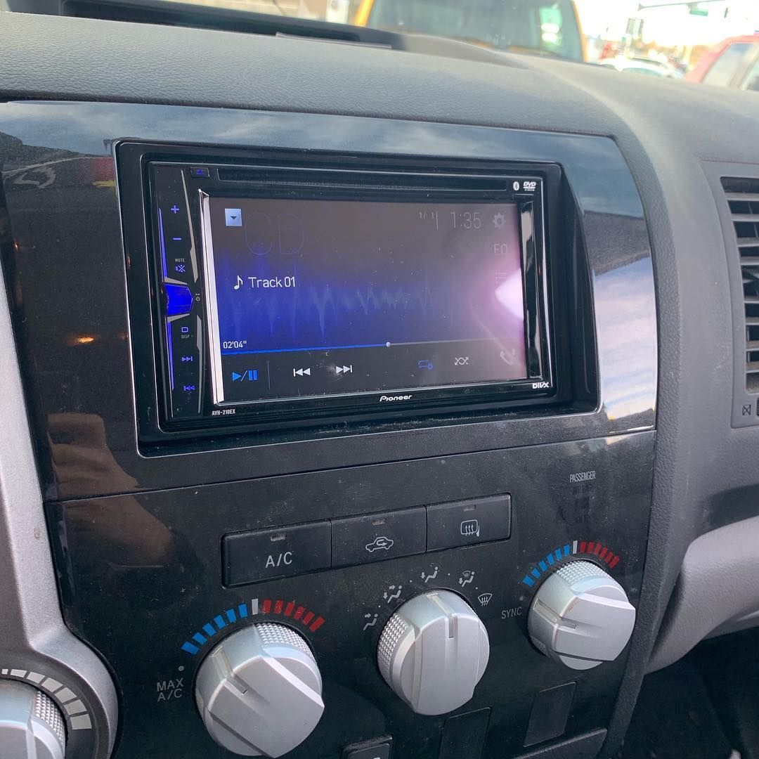 The dashboard of a car with a radio and headphones.