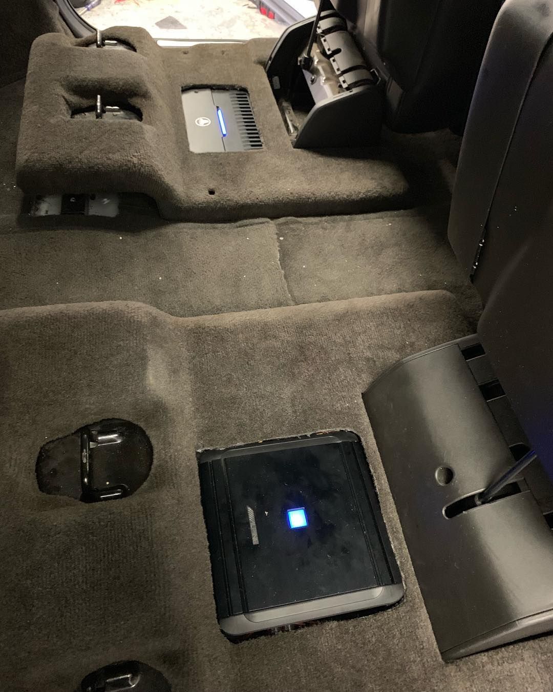 A car radio displays the time as 12:03