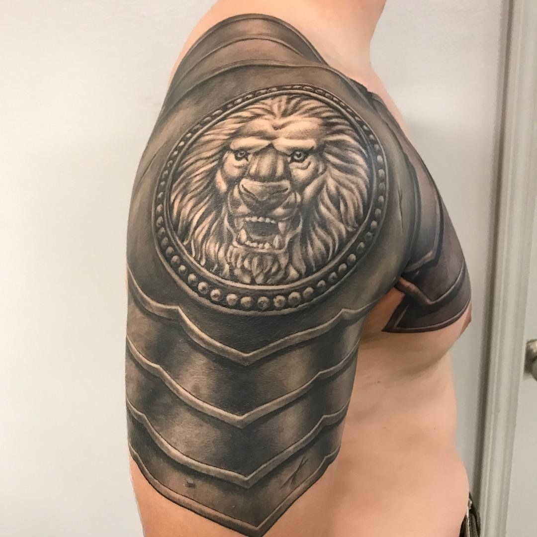 A man has a tattoo of a lion on his shoulder