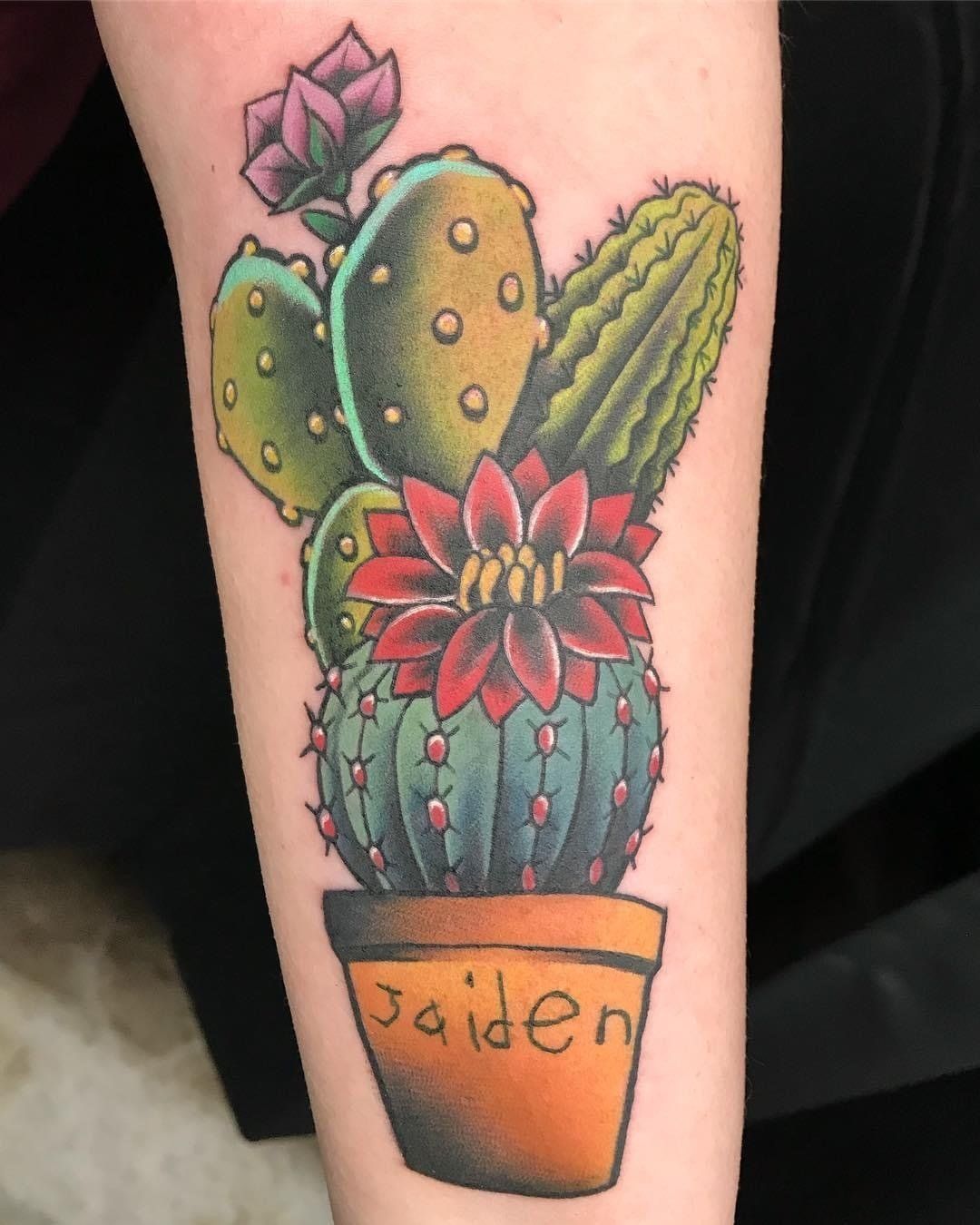 A tattoo of a cactus in a pot with the name jaiden on it