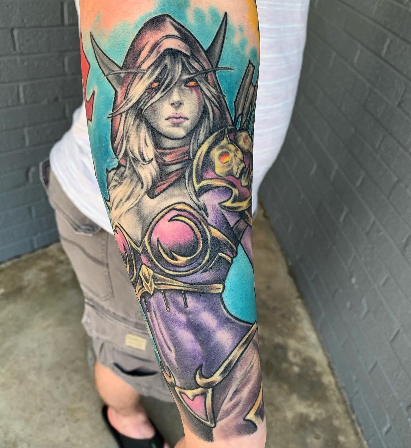 A woman has a tattoo of a warrior on her arm.