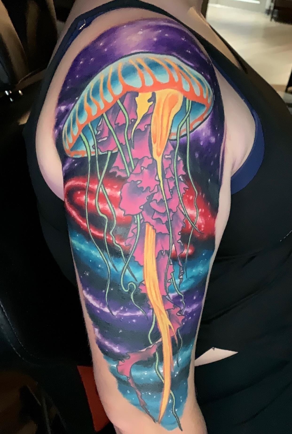 A woman has a jellyfish tattoo on her arm.