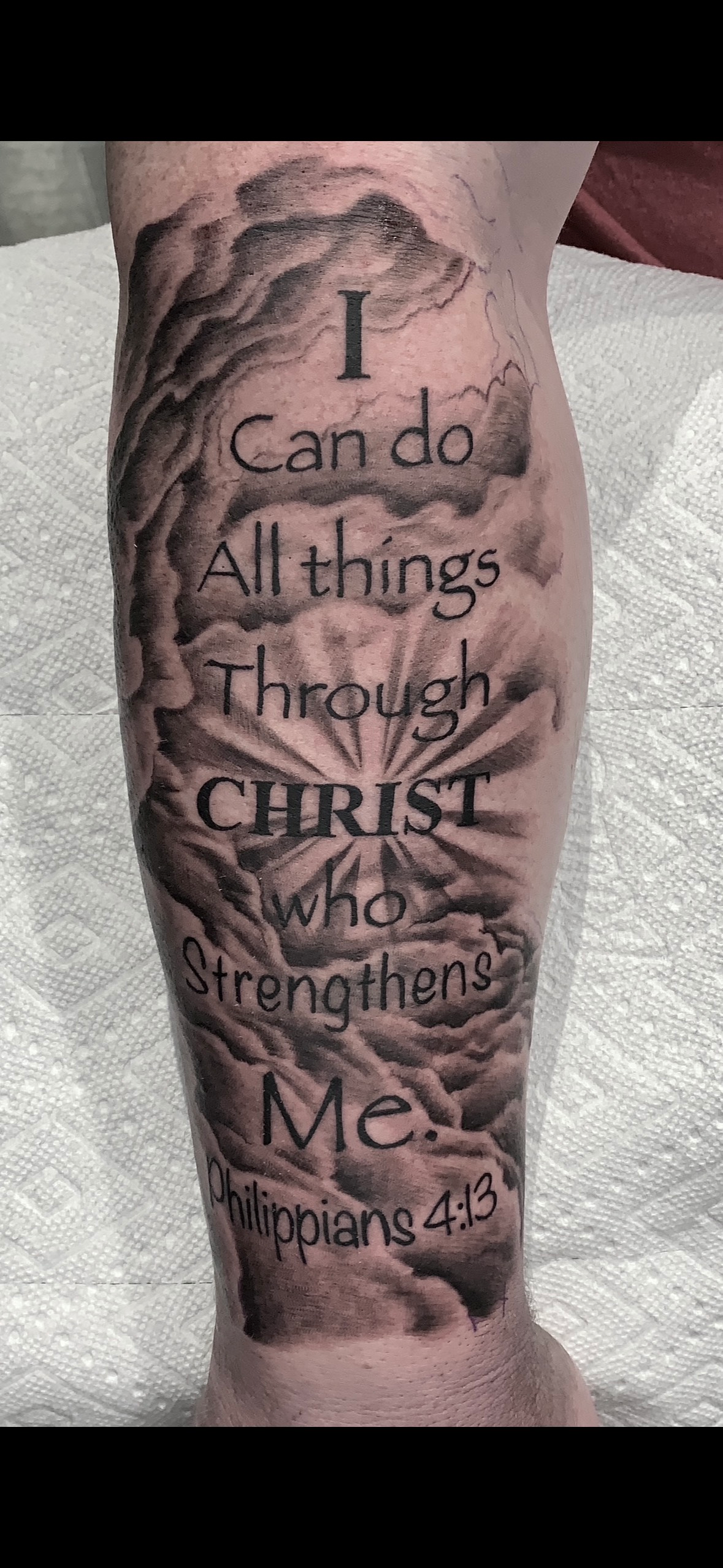 A person has a tattoo on their leg that says `` i can do all things through christ who strengthens me ''.