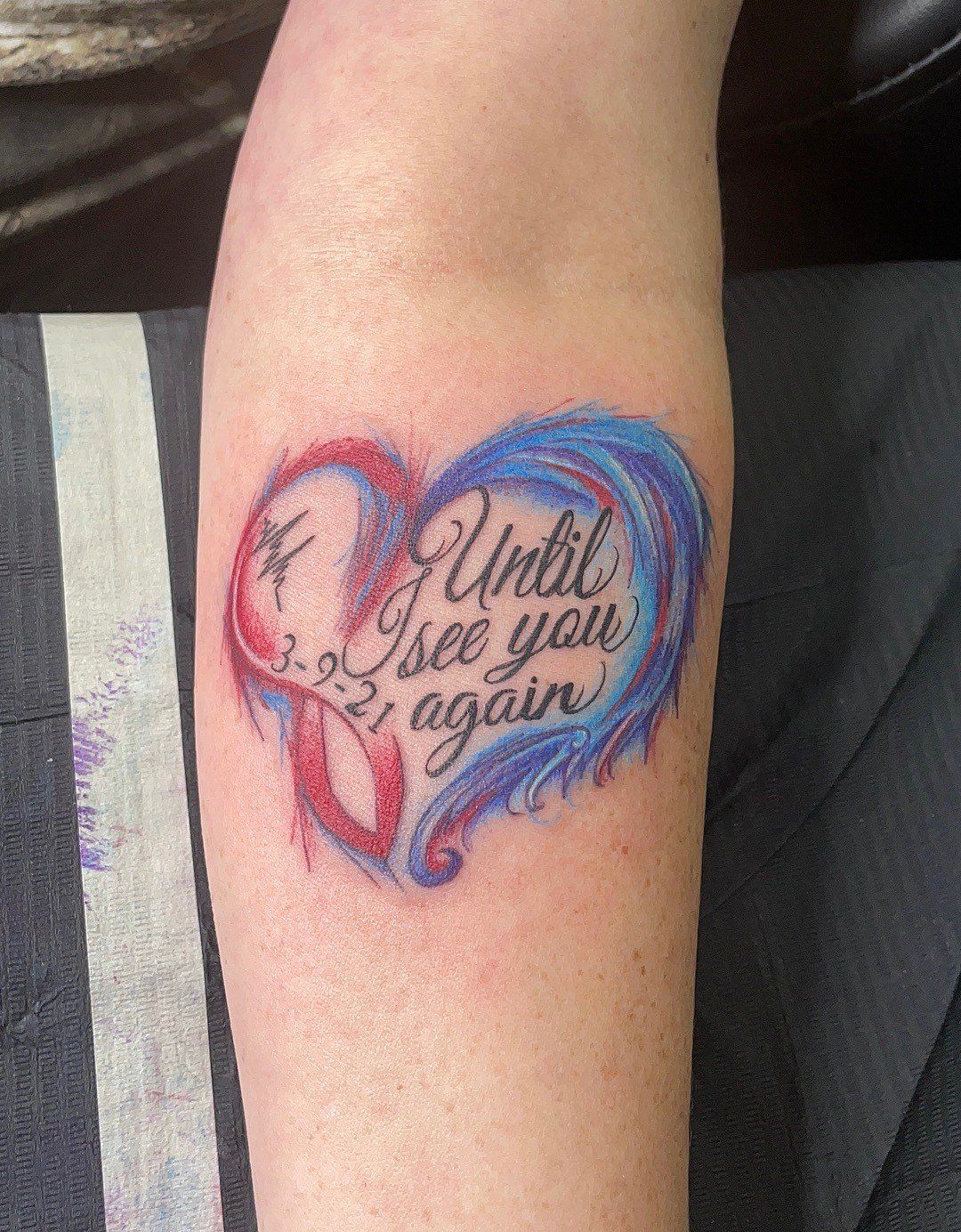 A person has a tattoo on their arm that says `` until i see you again ''.