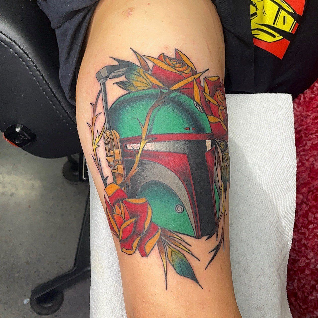 A person has a boba fett tattoo on their arm