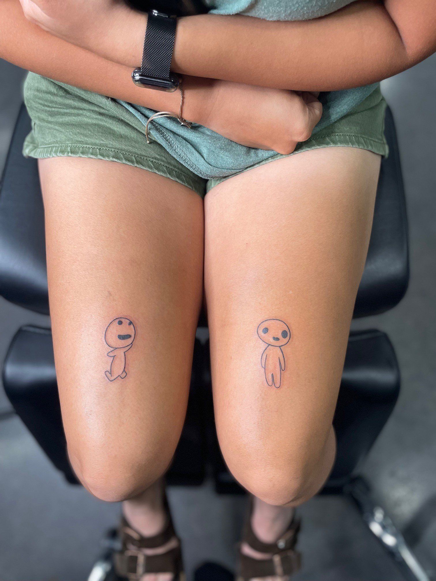 A woman has two small tattoos on her legs